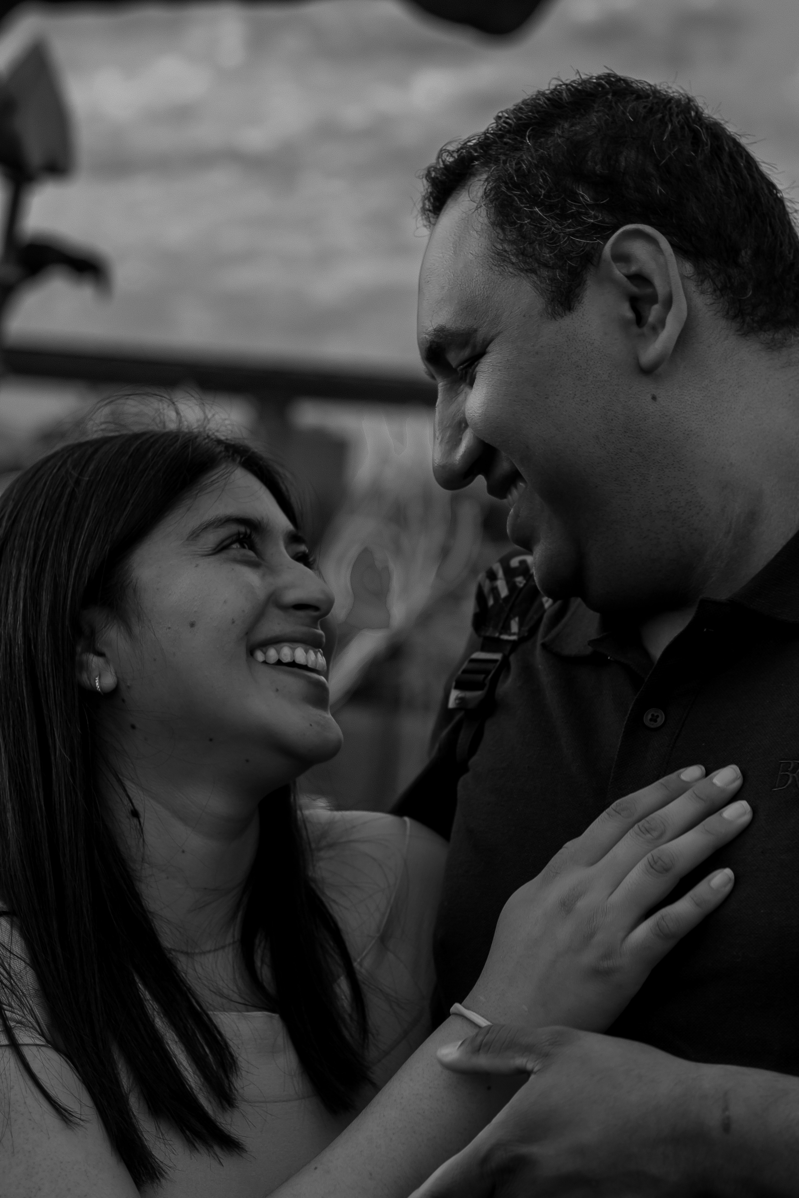 portrait of a couple looking at each other smiling